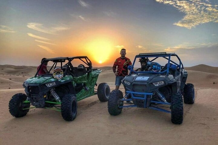 Experience the majestic desert landscape at sunset while embracing the excitement of driving your own dune buggy creating unforgettable memories in Dubai's stunning surroundings.